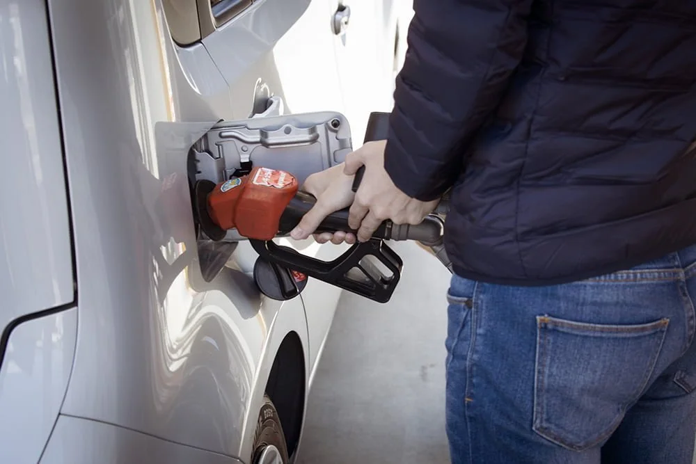 Person pumping gas into their car | Proposed gas tax | Deer Park Gazette