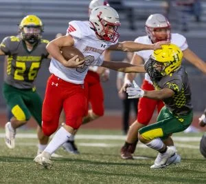 #3 Tyler Lenz stiff arms a Shadle Park defender.